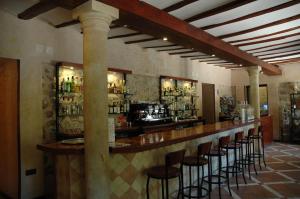 a bar in a restaurant with stools in a room at Hotel Arabia in Albarracín