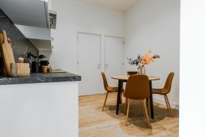 a kitchen and dining room with a table and chairs at Spacious home, 10 min from Efteling in Tilburg