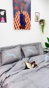 a bedroom with a bed with a book on it at Home sweet hotel&apartment in Hanoi