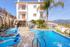 a hotel with a swimming pool in front of a building at Holiday Home Las Orquídeas in Viñuela