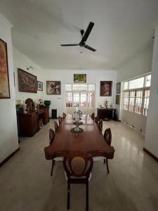 a dining room with a table and a ceiling fan at Nora Lyn - Colombo in Colombo +14 photos