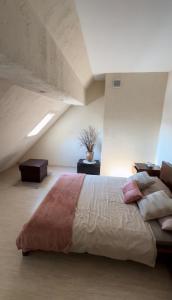 a bedroom with a large bed in a attic at Harbor Apartment in Ustka