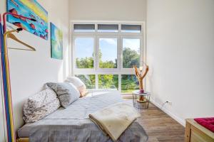 a bedroom with a bed in front of a window at Ferienhaus Ostroher Moor in Ostrohe