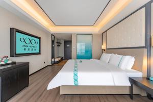 Voodi või voodid majutusasutuse XANA Hotel Qionghai Municipal Government High-speed Railway Station toas