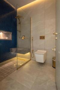 a bathroom with a glass shower and a toilet at Kyona Marina - كيونا مارينا in Jeddah