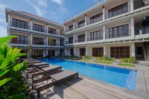 an image of a hotel with a swimming pool at Puri Kaja House in Badung