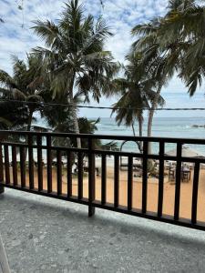 a view of the beach from the balcony of a resort at Turtle Beach House in Batigama