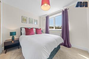 a bedroom with a large bed with purple curtains at 2 Bed Sleeps 4 in Dunfermline in Cairneyhill