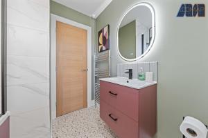 a bathroom with a pink vanity and a mirror at 2 Bed Sleeps 4 in Dunfermline in Cairneyhill