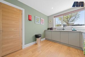 an empty kitchen with a large window and a door at 2 Bed Sleeps 4 in Dunfermline in Cairneyhill +27 photos