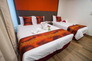 Postel nebo postele na pokoji v ubytování D'Spark Hotel Bayu