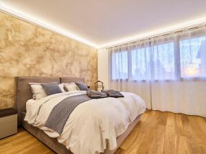 a bedroom with a large bed and a large window at Monza Design Villa by GIOs Private Pool in Monza +29 photos