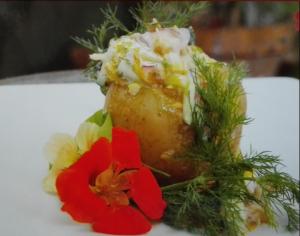 a piece of food on a white plate with flowers at Pension Spreewaldhof Leipe in Leipe +35 photos
