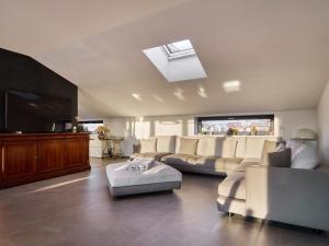 a large living room with a couch and a tv at Monza Design Villa by GIOs Private Pool in Monza