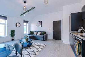 a living room with a couch and a table at Cohost Partners Central Apartment in Warrington in Warrington +39 photos