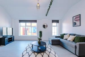 a living room with a couch and a table at Cohost Partners Central Apartment in Warrington in Warrington