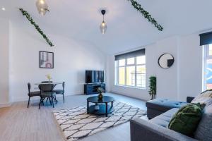 a living room with a couch and a table at Cohost Partners Central Apartment in Warrington in Warrington
