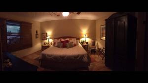 a bedroom with a bed and a table with a chair at A Dream Condo With Private Pool At 7 Seas Beach in Fajardo +8 photos