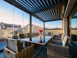 a dining room with a glass table and chairs at Monza Design Villa by GIOs Private Pool in Monza