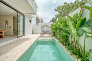 an indoor pool in a house with plants at New Luxury Moraira Villas in Badung