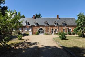 a large brick house with a roof at Château de Vaux in Vitry-aux-Loges