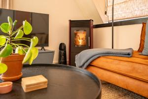 a bedroom with a bed and a table with a plant at Boshuisje Rekem - Topo in Lanaken +26 photos