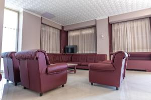 a waiting room with couches and a tv at Hotel Cristallo in Riolo Terme