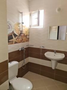 a bathroom with a toilet and a sink at Guest House Nedelchevi in Primorsko +70 photos