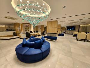 a large lobby with a blue couch in the middle at Elite Haven in Al Madinah