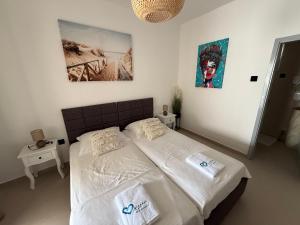 a bedroom with a bed with two pillows on it at Studio apartman Velvet in Biograd na Moru