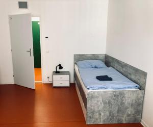 a bedroom with a bed in a room with a door at Hotel Astorka in Brno +4 photos