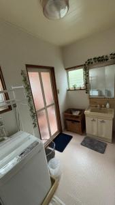 a small bathroom with a sink and a sink at SIBARIAN White House in Kaga +39 photos