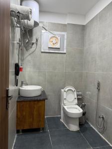 a bathroom with a toilet and a sink at Hotel 7 Heaven in Dehradun