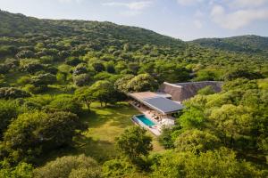 an aerial view of a house in the middle of a forest at Sungulwane Private Game Lodge in Hluhluwe