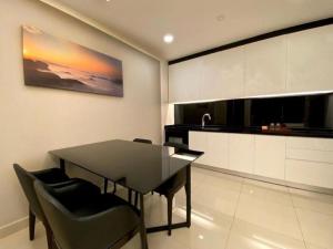 a dining room with a black table and chairs at Genting @ The MOST by NextGen in Genting Highlands +37 photos