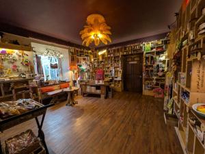 a shop with a large room with wooden floors and a chandelier at Farmhouse B&B Family stay or Romantic break, on our smallholding close to Narberth in Narberth