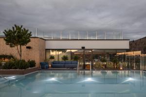 a large swimming pool in front of a building at Mountain Residence Wellness & SPA in Bukovel