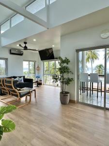 a living room with a couch and a table at Villa Miyoko Ko Yao Noi Enjoy nature's beauty and stunning sunsets in Ko Yao Noi