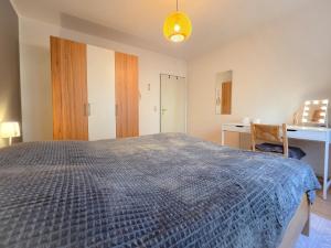 sypialnia z dużym łóżkiem i biurkiem w obiekcie Ferienwohnung SeeGräser Granitz w mieście Sellin