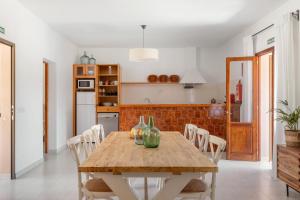 a dining room with a wooden table and chairs at Ca N'Alicia Des Bosch in Illes Balears +16 photos
