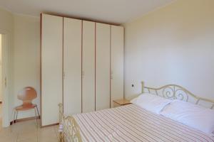 a bedroom with a large bed and a chair at Verde Acqua in Stresa +30 photos
