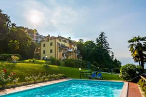 a swimming pool in front of a house at Verde Acqua in Stresa
