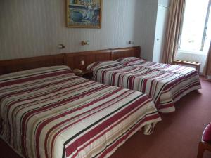 Postel nebo postele na pokoji v ubytování Cit'Hotel Avallon Vauban