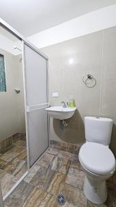 a bathroom with a toilet and a sink at Mom's House Colombia Casa 2 in Cali +11 photos