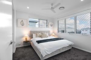 Ένα ή περισσότερα κρεβάτια σε δωμάτιο στο Brisbane Family House with Ensuite&Centralised A/C