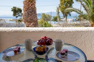 a glass table with a bowl of fruit on it at Stefanie Studios in Egina