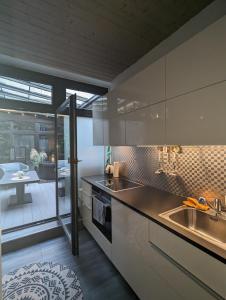 a kitchen with a sink and a counter top at Luxus Ferienwohnung Troisdorf in Troisdorf +32 photos