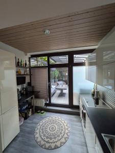 a kitchen with a large window and a table at Luxus Ferienwohnung Troisdorf in Troisdorf