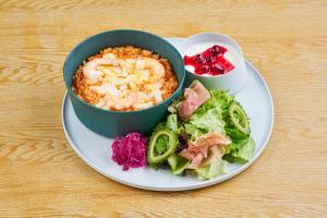 a plate with a bowl of food and a salad at BEB5 Okinawa Seragaki by Hoshino Resorts in Onna