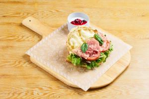 a sandwich on a napkin on a wooden table at BEB5 Okinawa Seragaki by Hoshino Resorts in Onna
